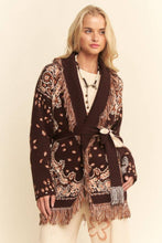 Load image into Gallery viewer, Chocolate brown tapestry-inspired jacquard knit cardigan with shawl collar, self-tie belt and multicolor fringe trim.