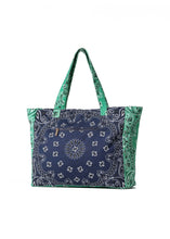 Load image into Gallery viewer, Oversized navy and green cotton canvas tote featuring a patchwork bandana paisley print, green side panels and matching shoulder straps on a white background.