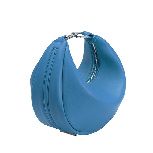 Effortlessly blend fashion and functionality with our Blue Vegan Leather Round Crossbody. The bag's silver hardware adds a hint of sophistication to its sleek design, making it a perfect complement to your daily ensembles. Clip both ends to create a handle and carry your most valued essentials. 