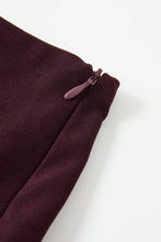 Load image into Gallery viewer, Burgundy asymmetric twill mini skirt featuring cascading sculptural ruffles and a dramatic elongated side hem on a white background.