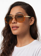 Load image into Gallery viewer, Oversized square aviator sunglasses with translucent orange frame and gold metal bridge with tinted lenses.