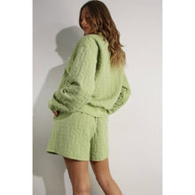 Load image into Gallery viewer, Apple green embossed half-zip pullover with relaxed fit and textured fabric styled as a chic lounge top.