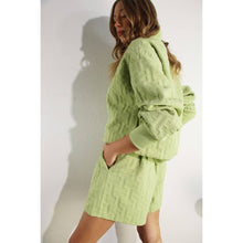 Load image into Gallery viewer, Apple green embossed half-zip pullover with relaxed fit and textured fabric styled as a chic lounge top.