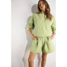 Load image into Gallery viewer, Apple green embossed half-zip pullover with relaxed fit and textured fabric styled as a chic lounge top.