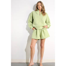 Load image into Gallery viewer, Apple green embossed lounge shorts with relaxed fit and textured fabric styled as part of a matching set.