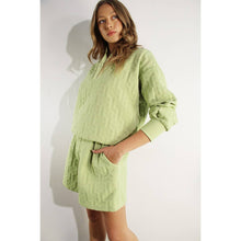 Load image into Gallery viewer, Apple green embossed lounge shorts with relaxed fit and textured fabric styled as part of a matching set.