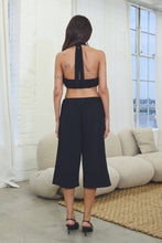 Load image into Gallery viewer, Black French terry Bermuda shorts with oversized silver grommet details, elastic drawstring waist, relaxed fit, and stretch fabric.