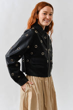 Load image into Gallery viewer, Woman wearing a Glam Expressway black jacket with grommets on a white background