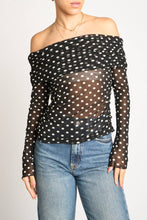 Load image into Gallery viewer, Black polka dot off-shoulder top worn by a person on a plain background