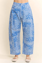 Load image into Gallery viewer, Blue wide-leg cotton pants featuring an allover white paisley bandana print, high-rise waist, relaxed fit, and cropped wide-leg silhouette styled with white lace flats.