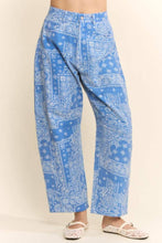 Load image into Gallery viewer, Blue wide-leg cotton pants featuring an allover white paisley bandana print, high-rise waist, relaxed fit, and cropped wide-leg silhouette styled with white lace flats.
