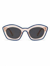 Load image into Gallery viewer, Blue trim cat-eye sunglasses with a translucent frame and dark tinted lenses on a clean white background.