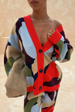 Load image into Gallery viewer, Colorful cardigan with geometric pattern worn by a person on a beige background