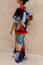 Load image into Gallery viewer, Woman wearing a colorful patterned Cardigan Sweater from Glam Expressway against a beige background