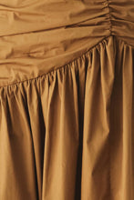 Load image into Gallery viewer, Caramel brown cotton midi skirt with a shirred waist, gathered full silhouette and dramatic asymmetrical draped hem.