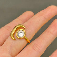 Load image into Gallery viewer, 18K gold-plated stainless steel ring featuring a sculptural crescent moon and large round clear zircon stone.