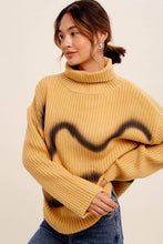 Load image into Gallery viewer, Woman wearing a mustard yellow sweater with a black heart design on a beige background