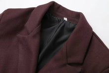 Load image into Gallery viewer, Close-up of a maroon coat with a white label on a light gray background