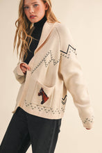 Load image into Gallery viewer, Woman wearing a cream-colored cardigan with a pocket design on a beige background