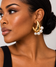 Load image into Gallery viewer, Oversized sculptural gold-tone crescent earrings with a hammered high-shine finish and clusters of large white pearl accents.