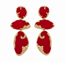 Load image into Gallery viewer, Bold red acrylic statement drop earrings with textured gold-tone detailing in an abstract sculptural design on a white background.