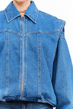 Load image into Gallery viewer, Model wearing an indigo denim bomber jacket with structured shoulders, zip-front closure, elastic hem, and gathered cuffs against a white background.