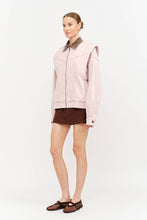 Load image into Gallery viewer, Front view of model wearing dusty rose oversized denim jacket with brown corduroy collar, zip front and structured shoulders.