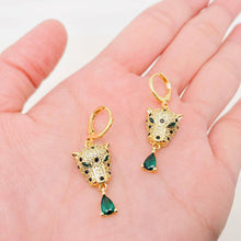 Load image into Gallery viewer, Gold-plated leopard head huggie earrings with crystal details, green eyes and dangling emerald-green teardrop cubic zirconia stones.
