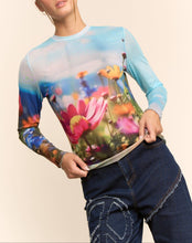 Load image into Gallery viewer, Sheer long sleeve mesh top with vibrant floral field print in soft focus colors, worn by a model.