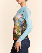 Load image into Gallery viewer, Sheer long sleeve mesh top with vibrant floral field print in soft focus colors, worn by a model.