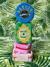 Load image into Gallery viewer, Stack of decorative boxes with 'Caviar' and 'Living Royal' branding on a leafy green background