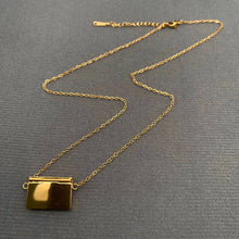 Load image into Gallery viewer, Gold-plated envelope pendant necklaces displayed on gray fabric, including the red heart zircon version with a polished gold finish and delicate chain.