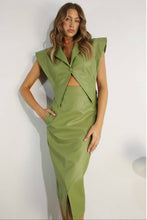 Load image into Gallery viewer, Woman wearing a green outfit with a matching vest and skirt against a white background