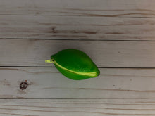 Load image into Gallery viewer, Realistic lime-shaped coin purse with zipper, keychain ring, and bag charm attachment displayed on a wood background.
