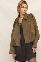 Load image into Gallery viewer, Woman wearing a green jacket over a black dress on a plain background