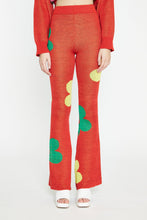 Load image into Gallery viewer, Like its matching sweater, the Red Glitter Floral Knit Pants are attention-grabbing with their metallic sheen and fun print. These cherry red knit pants have a yellow and green floral print, a subtle shimmer and lots of stretch.