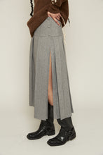 Load image into Gallery viewer, Elevate your style with our insanely chic grey Pleated Split Midi Skirt. Crafted with exceptional quality, this versatile piece features a sophisticated pleated design with a subtle side split for a touch of allure. Hand washable and available in sizes XS to XL, it’s the perfect addition to your wardrobe for effortless elegance.