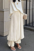 Load image into Gallery viewer, Ivory lightweight harem pants featuring a flowy crinkle texture and gathered cuffs, styled for vacation, resort, and coastal-inspired outfits.