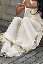 Load image into Gallery viewer, Ivory lightweight harem pants featuring a flowy crinkle texture and gathered cuffs, styled for vacation, resort, and coastal-inspired outfits.