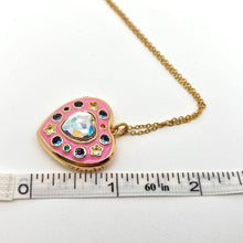 Load image into Gallery viewer, Open pink enamel heart locket necklace with colorful cubic zirconia stones, crystal heart centerpiece and gold-plated chain.