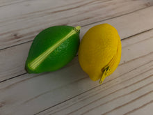 Load image into Gallery viewer, Realistic lime-shaped coin purse with zipper, keychain ring, and bag charm attachment displayed on a wood background.