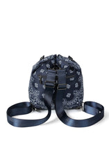 Load image into Gallery viewer, Navy blue bandana print convertible bucket bag with drawstring closure and adjustable straps that can be worn as a backpack, shoulder bag, or crossbody bag.