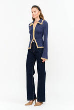Load image into Gallery viewer, Model wearing The Aspen Double Zip Knit Cardigan in navy with contrast fuzzy trim, double zipper, flared sleeves, and wide-leg dark wash jeans.