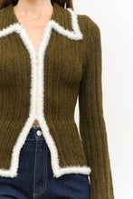 Load image into Gallery viewer, Close-up of olive green textured knit sweater top featuring an ivory fuzzy-trimmed pointed collar, two-way silver zipper, fitted waist, and contrasting ivory trim.