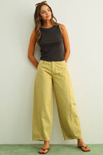 Load image into Gallery viewer, Olive green high-rise wide-leg jeans with relaxed barrel silhouette styled with sandals for an effortless everyday look.