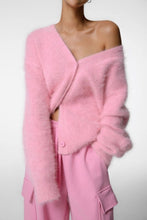 Load image into Gallery viewer, Model wearing a soft blush pink fuzzy cashmere blend cardigan sweater styled off the shoulder with matching pink cargo style pants.