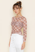 Load image into Gallery viewer, Woman wearing a plaid top and white pants against a beige background