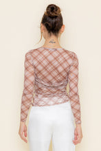 Load image into Gallery viewer, Person wearing a plaid long-sleeve top and white pants against a beige background