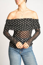 Load image into Gallery viewer, Black polka dot off-shoulder top worn by a person on a plain background