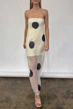 Load image into Gallery viewer, Woman wearing a chic Glam Expressway slip dress with black polka dots on a plain background
